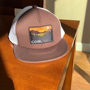 Coal brand trucker hat with dark brown front and white mesh on crown and back